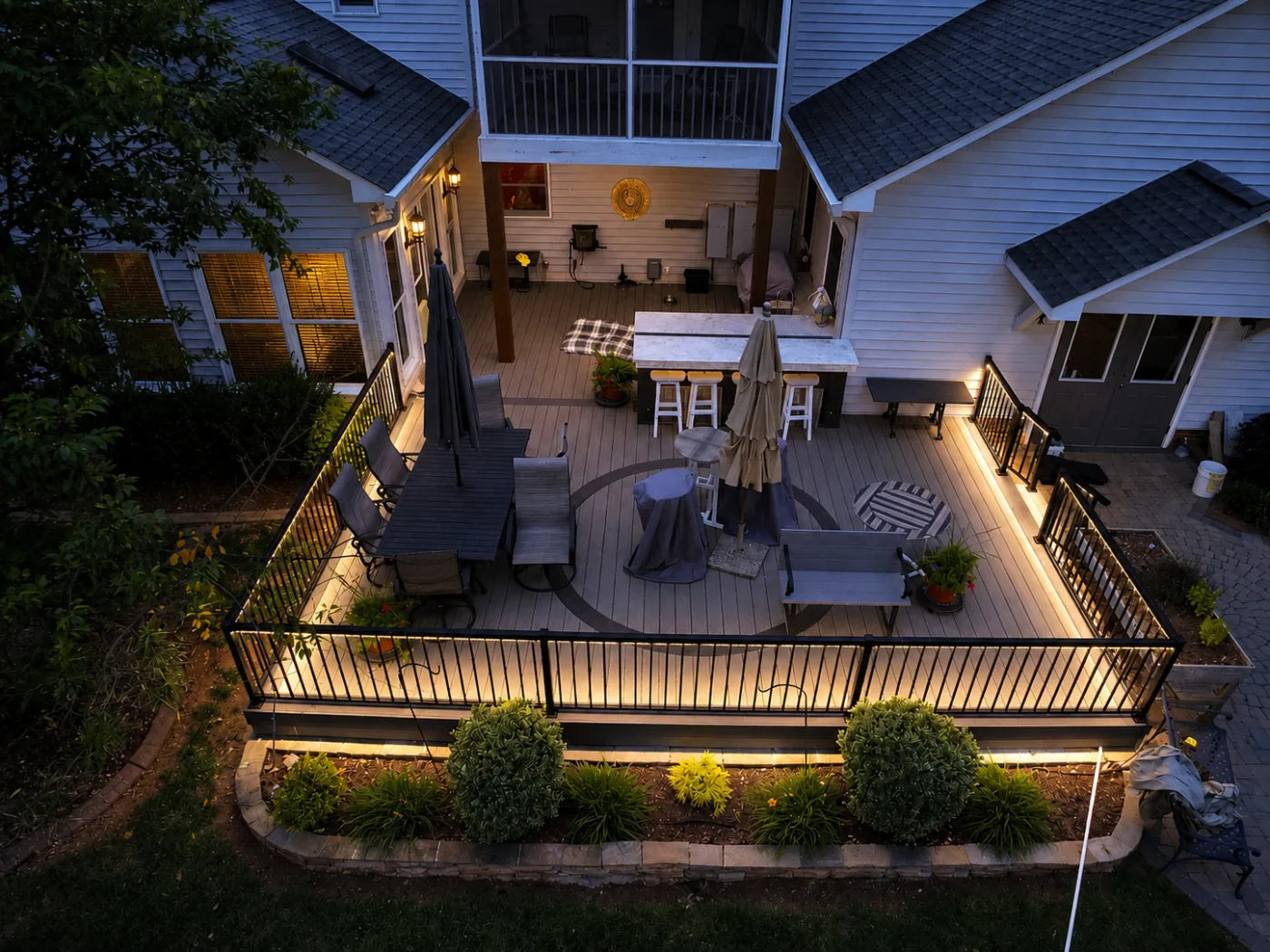 Deck and landscape illuminated with low-voltage outdoor lighting at dusk in Charlotte, NC