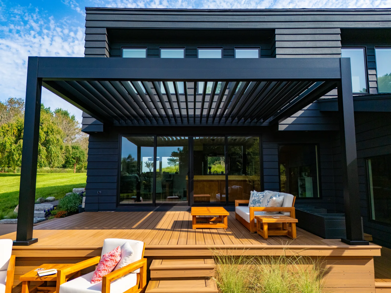 Modern black louvered pergola over a wood deck in Charlotte, NC